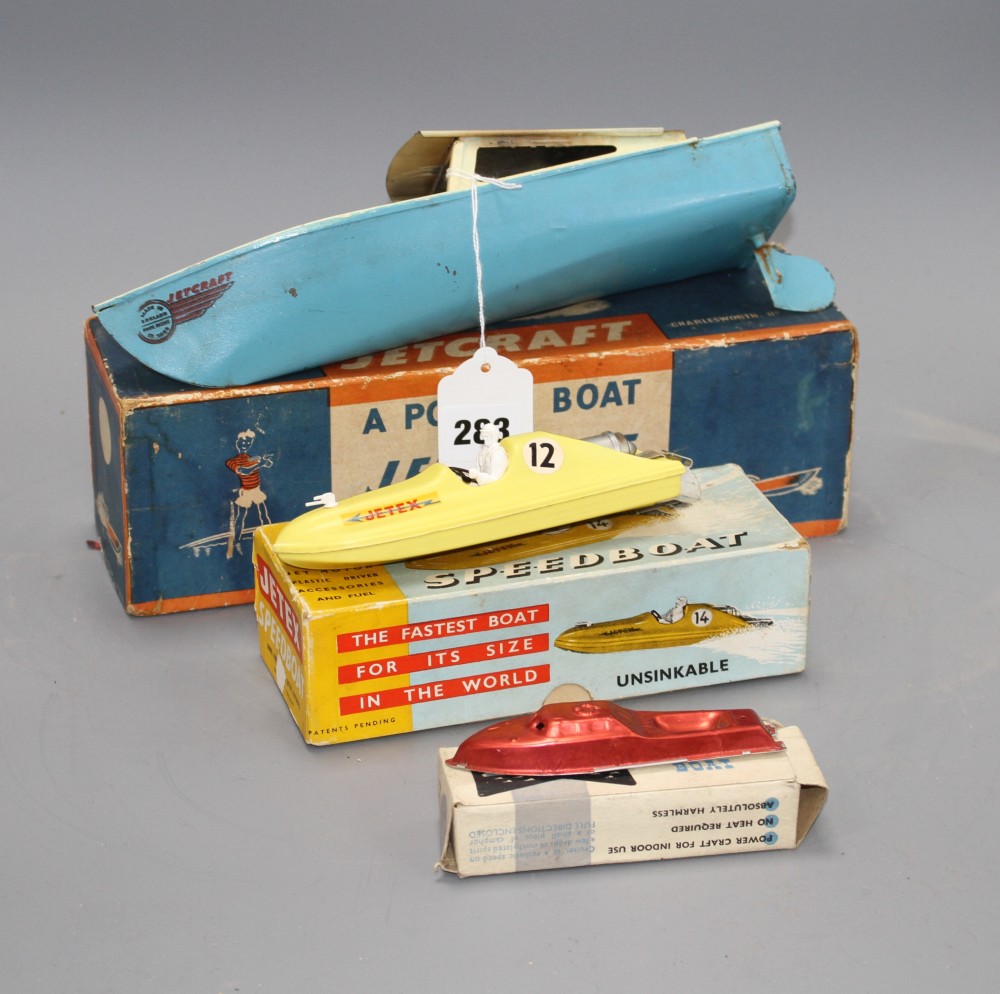 A boxed Jetex plastic fuel propelled model boat, a Jetcraft tinplate burner propelled model power boat and a boxed Mechanex pressed foi